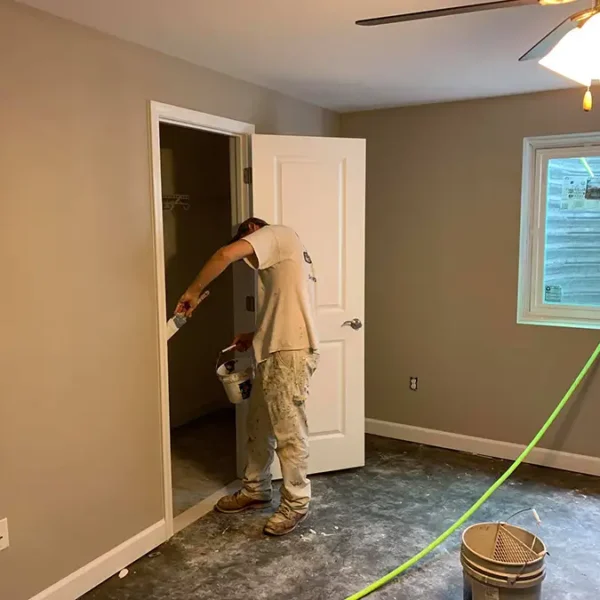 Tyler Painting and Drywall Co. - professional painting the closet door frame in a basement bedroom - Fairview Heights, IL