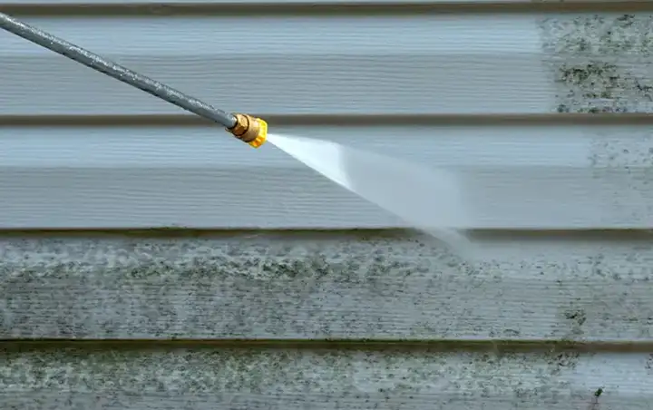 Power or Pressure Washing in progress, washing the vinyl siding of a house - Fairview, Heights, IL